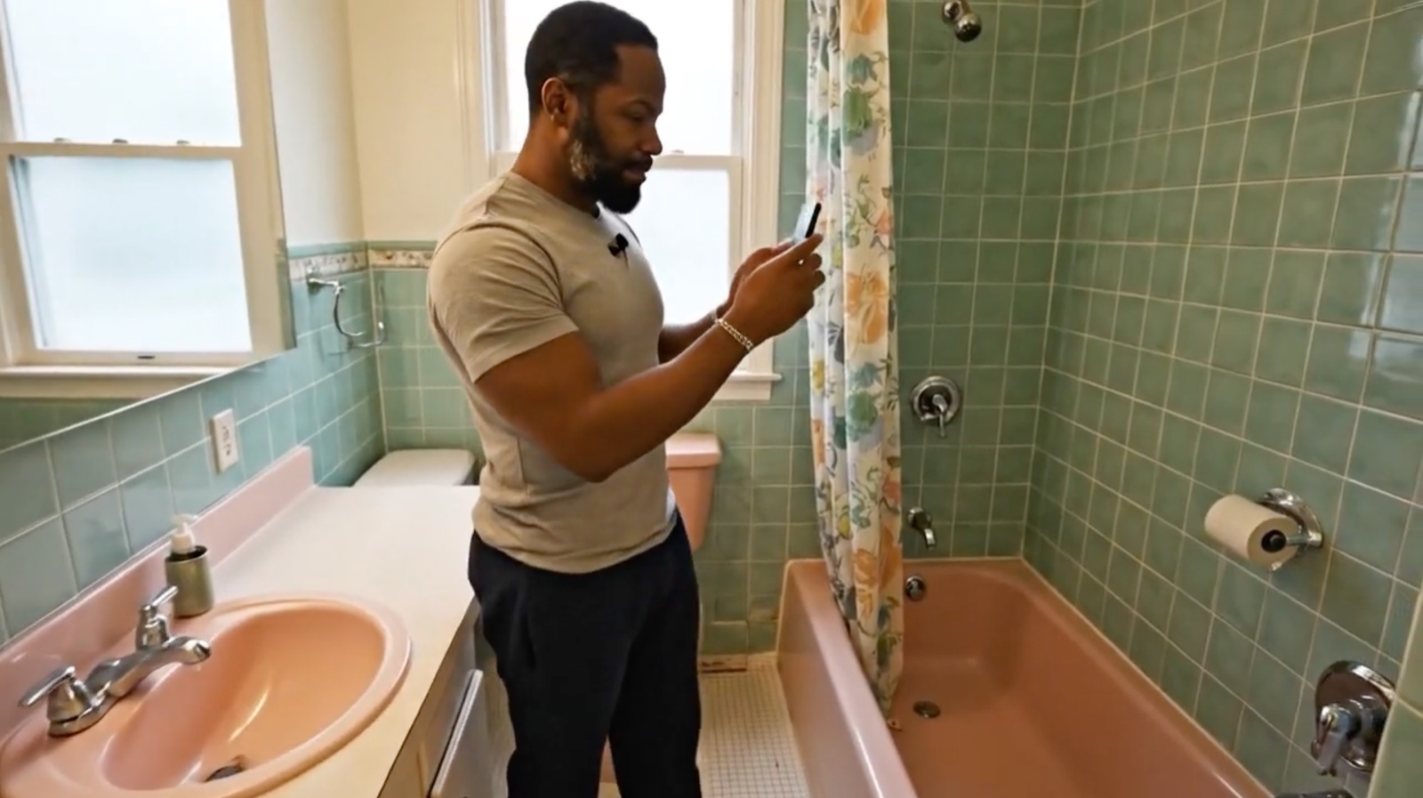 Homeowner filming a bathroom walkthrough on phone